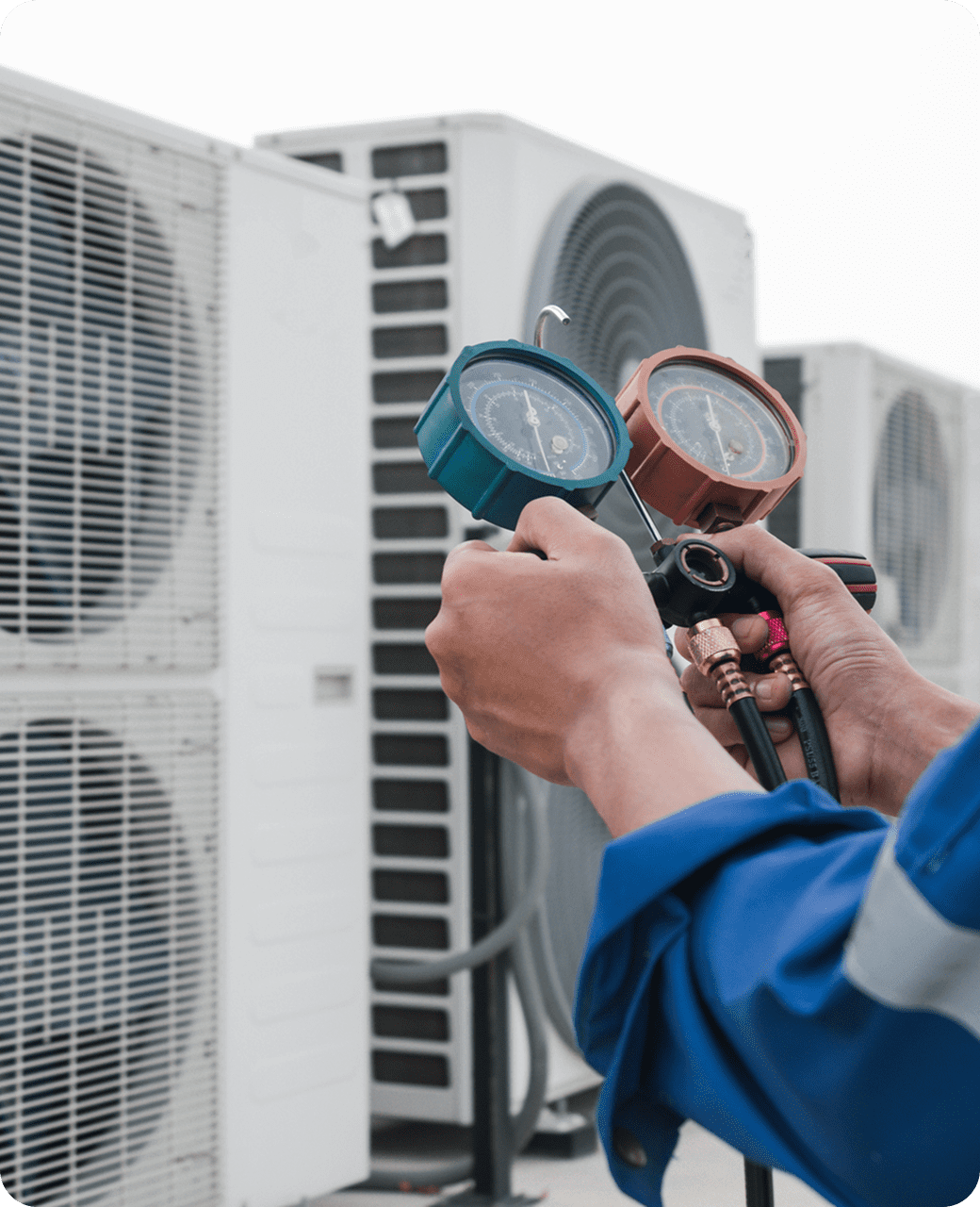 Hands holding HVAC pressure gauges