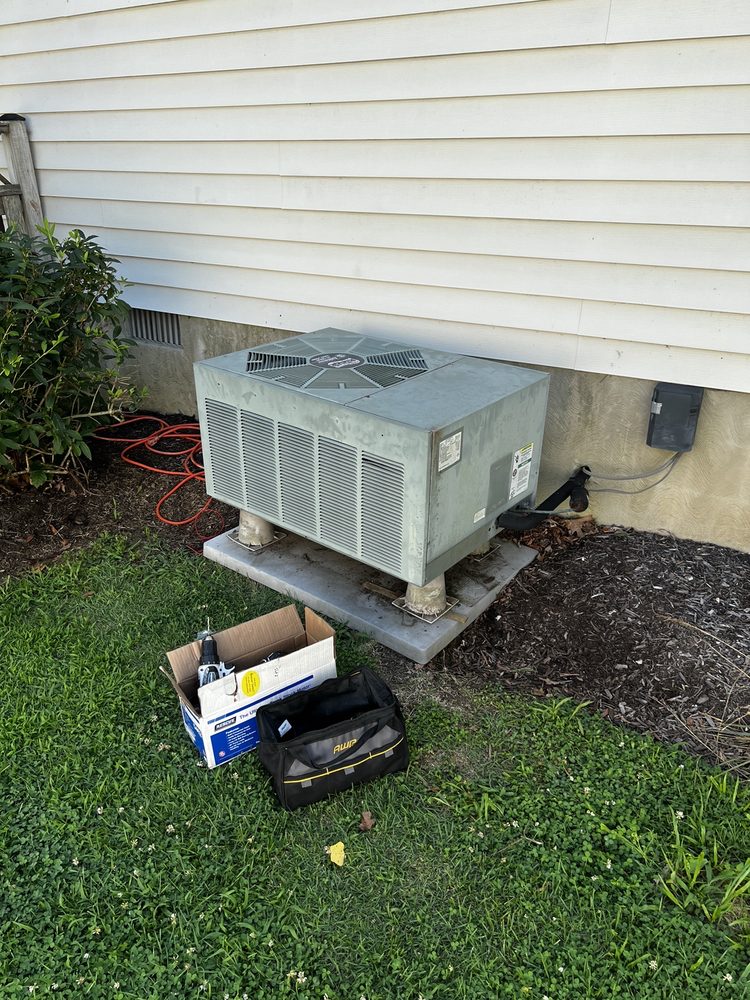 HVAC Contractor in Downtown Annapolis, MD 2 Older HVAC unit installed by the HVAC contractor in Downtown Annapolis, MD, with tools nearby for maintenance.