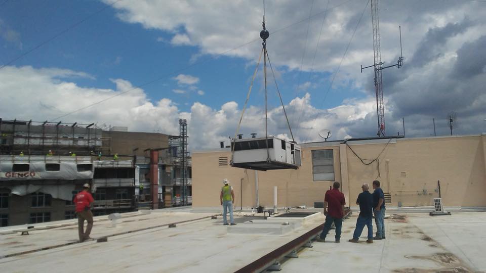 Commercial rooftop AC installation with HVAC crew installing new air conditioning unit in Edgewater MD.