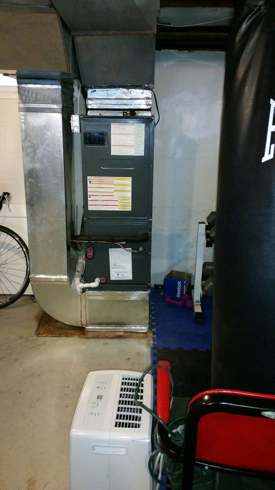 Residential HVAC contractor installing indoor heating and cooling system in Parole MD
