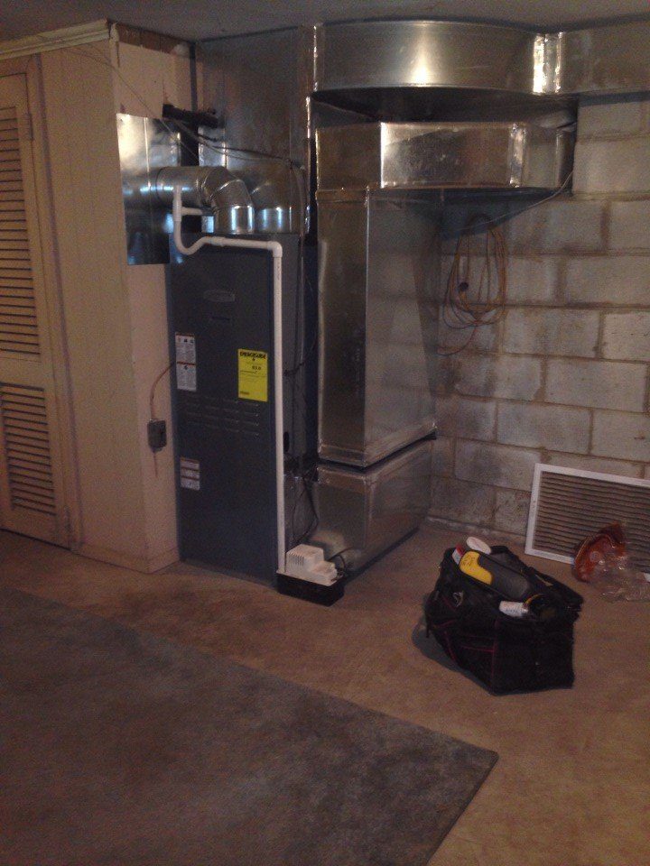 Home heating furnace unit and ductwork system with service tool bag in an Annapolis, MD basement.